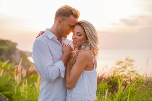 istock Affectionate couple embrace outdoors at sunset 961261778