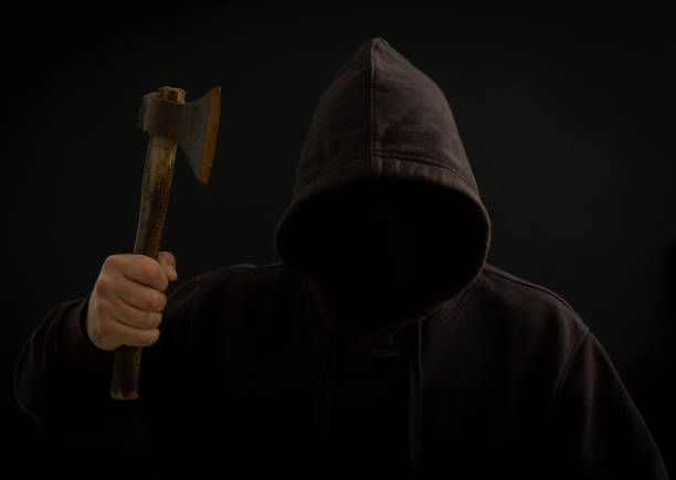 istock A killer with a hatchet in his hand in the dark 961266794