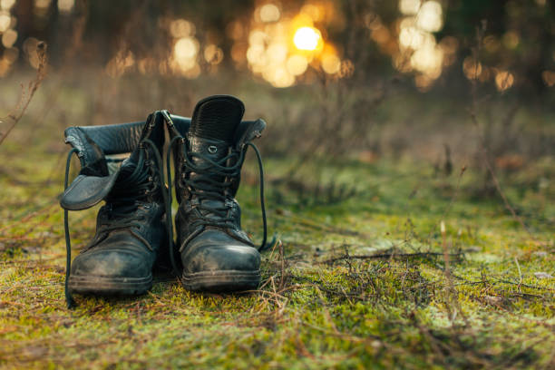 gros vintage paire de bottes de marche sur fond de prairie de boulder. - combat boots photos et images de collection
