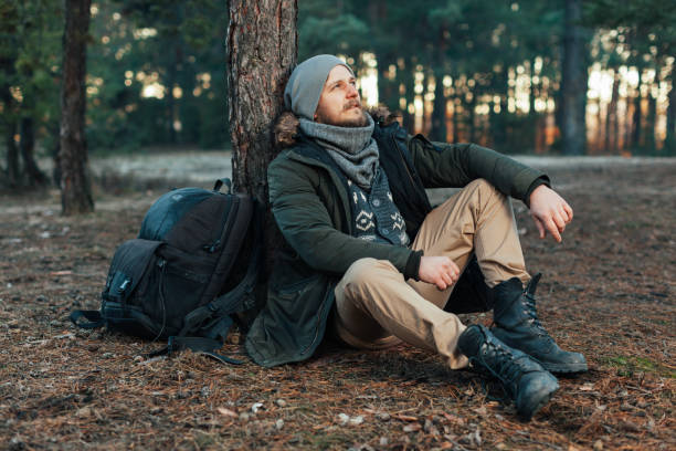 istock Pensive hipster guy wanderlust with touristic backpack enjoy tranquility during exploring nature environment, 961269996