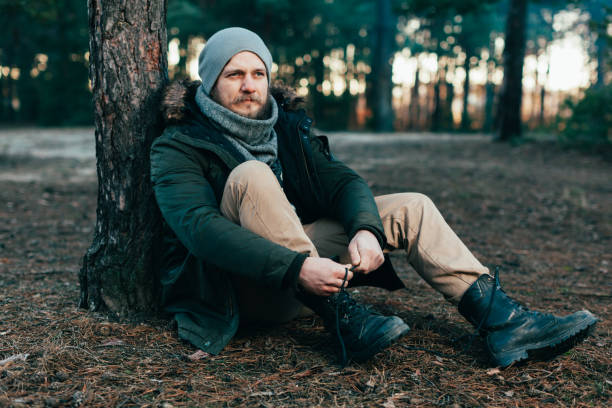 istock Pensive hipster guy wanderlust with touristic backpack enjoy tranquility during exploring nature environment, male hiker thinking about route to discover 961270474