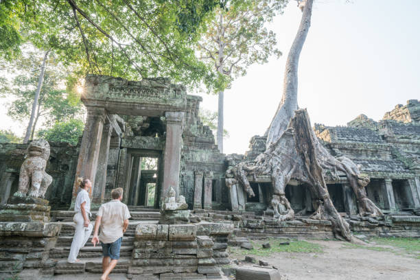istock Young couple contemplating ancient temple in Cambodia 961271146