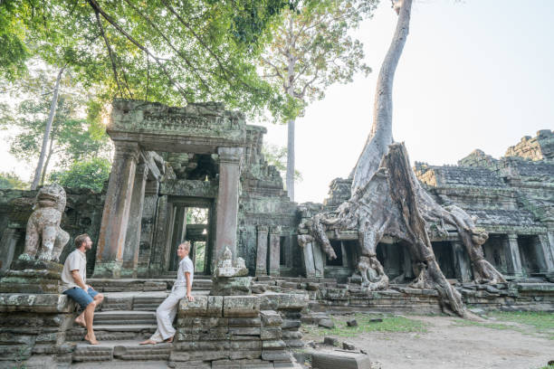 istock Young couple contemplating ancient temple in Cambodia 961271232