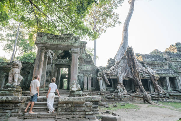 istock Young couple contemplating ancient temple in Cambodia 961271240
