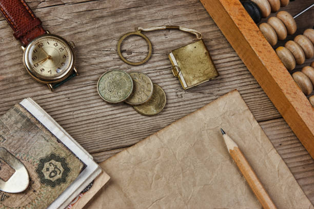 istock Old notes and coins and abacus on a wooden table 961271256