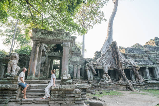 Young couple contemplating ancient temple in Cambodia