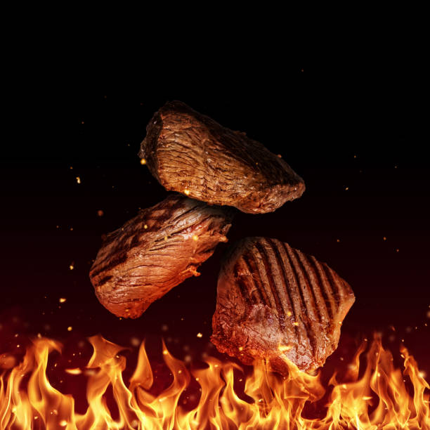istock Flying pieces of beef rump steaks on black 961276242