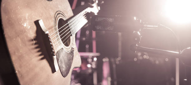 istock The Studio microphone records an acoustic guitar close-up. Beautiful blurred background of colored lanterns. 961278824
