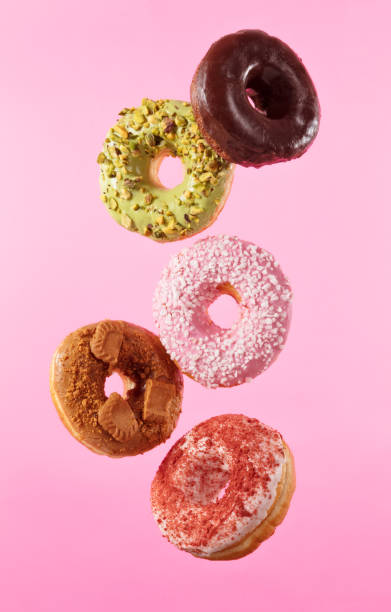 istock Flying sweet donuts isolated on pink background. 961279418