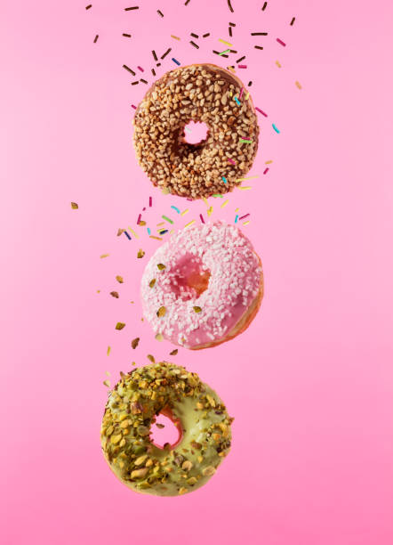 istock Flying sweet donuts isolated on pink background. 961279546