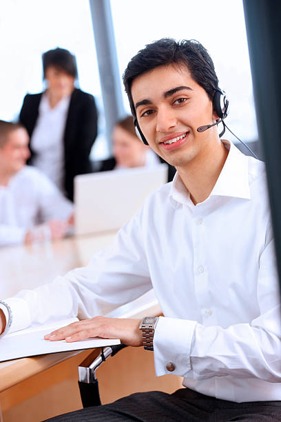 istock young Indian call centre working in office with colleagues 96128164