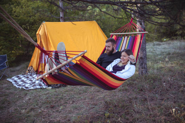 istock Romantic hipster couple enjoy rest on a hammock 961283168