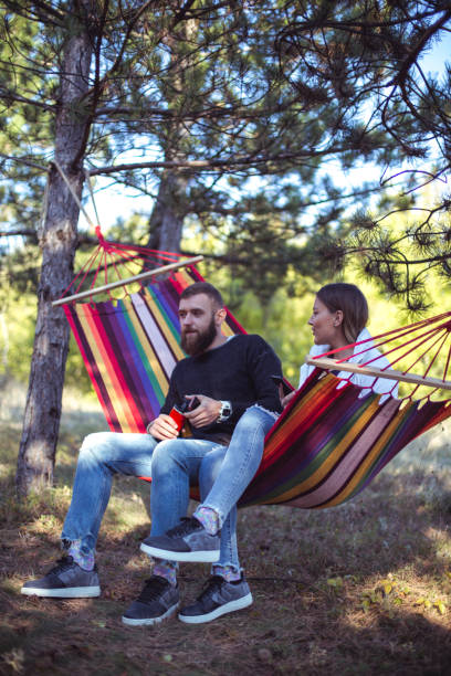 istock Romantic hipster couple enjoy rest on a hammock 961286860
