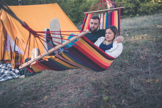 istock Romantic hipster couple enjoy rest on a hammock 961288394