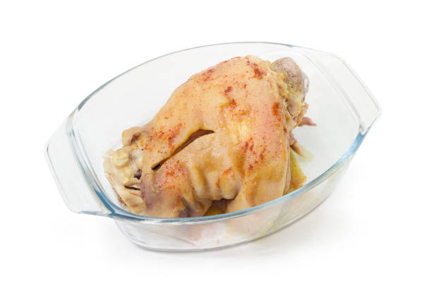 istock Baked ham hock in glass casserole pan on white background 961289342