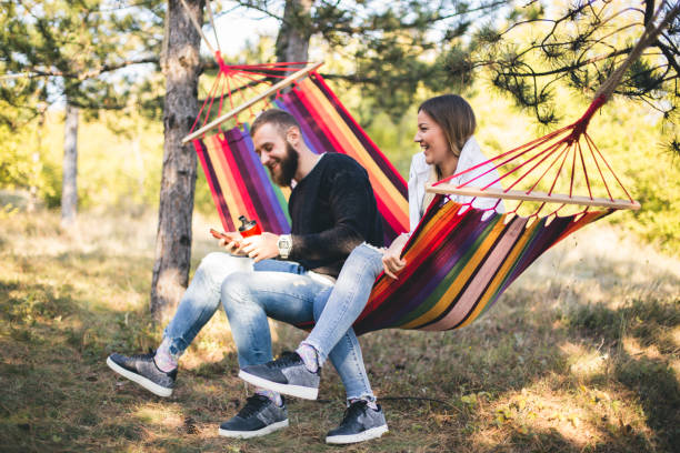 istock Romantic hipster couple enjoy rest on a hammock 961289422