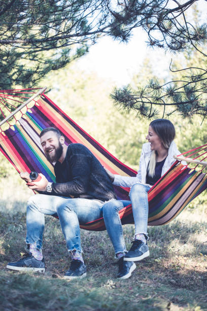 istock Romantic hipster couple enjoy rest on a hammock 961293820