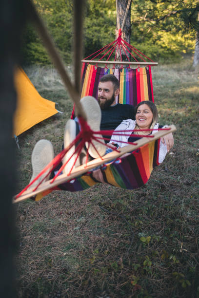 istock Romantic hipster couple enjoy rest on a hammock 961293868