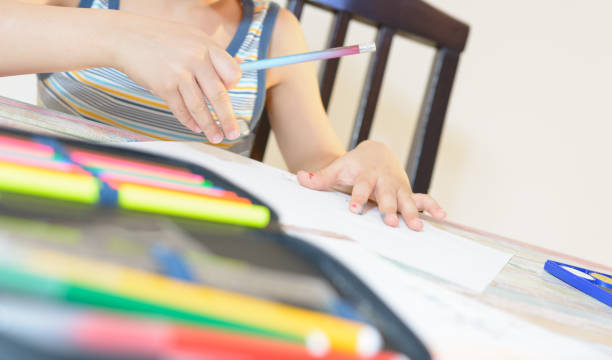 istock Boy is drawing with water color and colorful crayons. 961294952