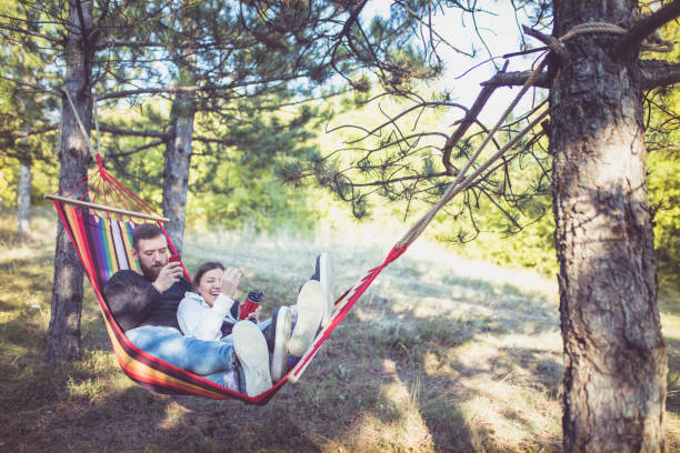 istock Romantic hipster couple enjoy rest on a hammock 961295068
