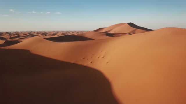 Aerial of sand dunes in Sahara desert at sunrise