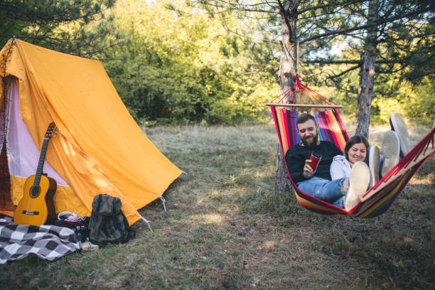 istock Romantic hipster couple enjoy rest on a hammock 961296372