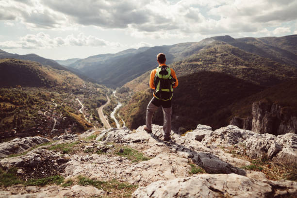 istock Hiker on the mountain top looking at view 961296648
