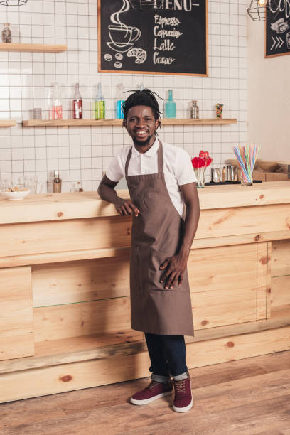 istock african american bartender standing at bar counter 961304464