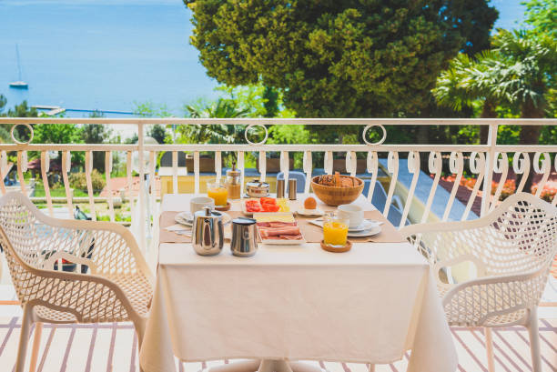 istock Continental morning breakfast table setting with sea view is served. 961308340