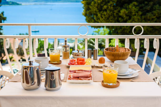 istock Continental morning breakfast table setting with sea view is served. 961308888