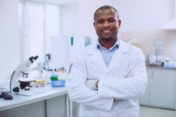 istock Smiling biologist standing in the lab 961310160