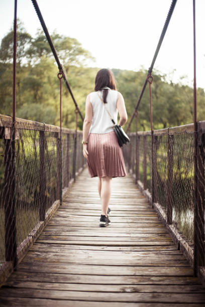 istock The girl walking on the bridge 961318588