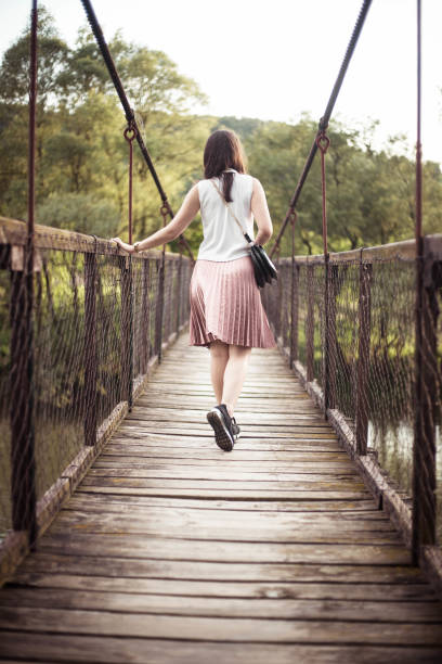 istock The girl walking on the bridge 961318606