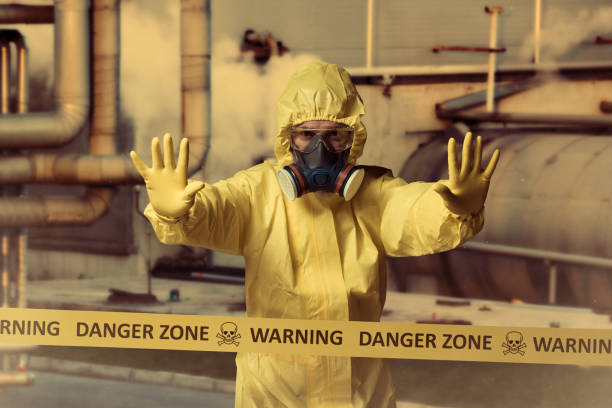 Danger zone Man wearing protective suit standing behind cordon tape ebola stock pictures, royalty-free photos & images