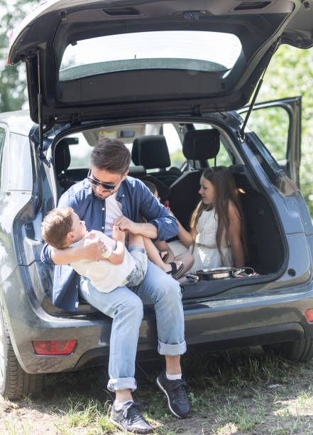 istock Happy father and three kids on road trip 961328298