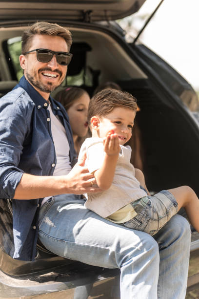istock Happy father and three kids on road trip 961328420