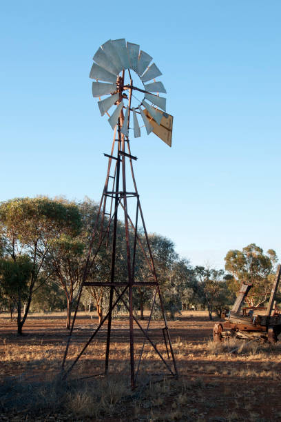 istock Windmill pumping water from artesian basin in the late afternoon sun 961333056