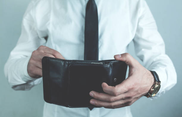 istock Businessman holding black leather wallet. 961335596