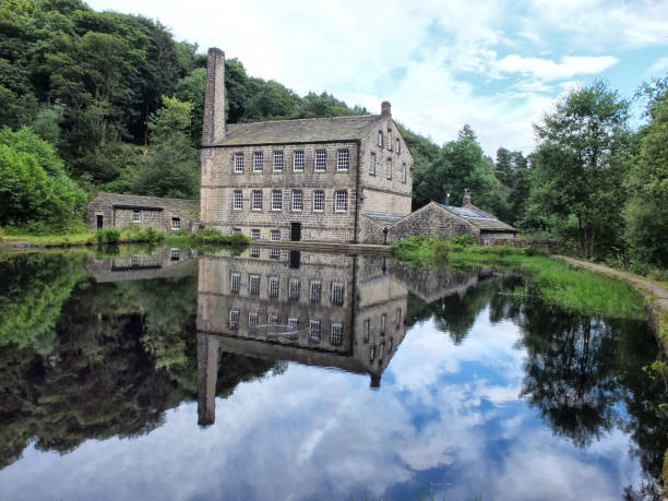 istock gibson mill a water powered mill with main bulding relected in the pond and surroounding trees of hardcastle crags near hebden bridge in west yorkshire 961340596