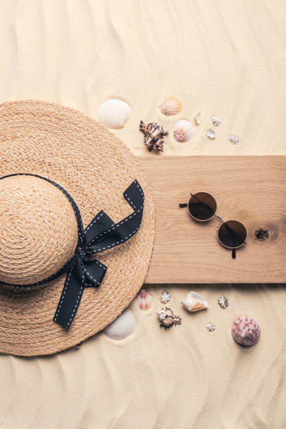 istock Straw hat with sunglasses on wooden pier on sandy beach 961341708