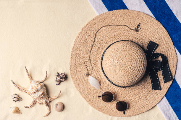 istock Straw hat with sunglasses and seashells on sandy beach 961349816