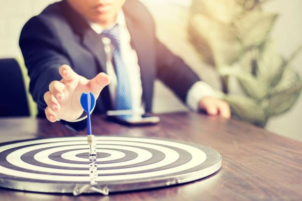 istock target and goal concept, businessman attempt to get dart on board 961350388