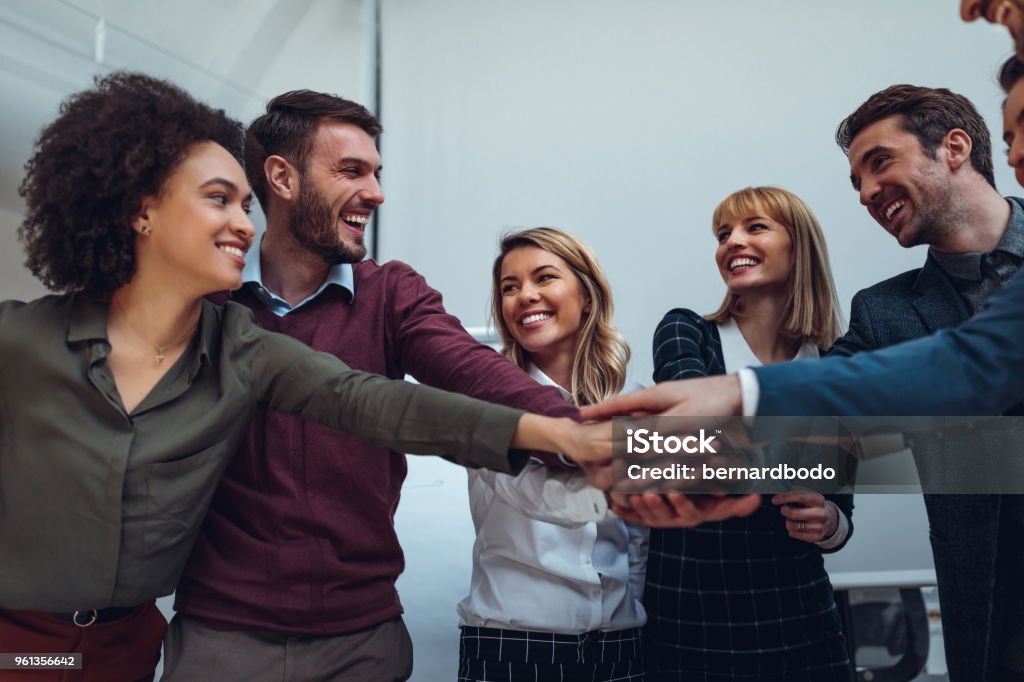 All in ! Close up of a group of businesspeople stacking their hands on top of each other Teamwork Stock Photo