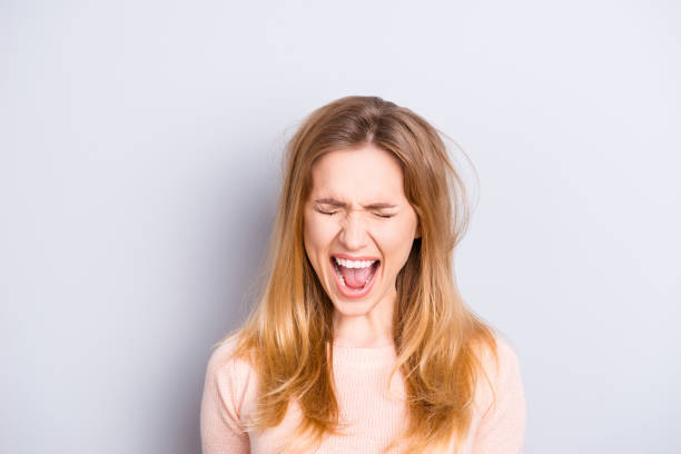 istock People emotion expressing loss dander dandruff shampoo lotion balm person concept. Close up portrait of unhappy sad upset crying shouting woman with open mouth closed eyes isolated gray background 961358138