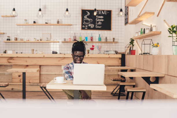 istock african american man using laptop in coffee shop 961360454