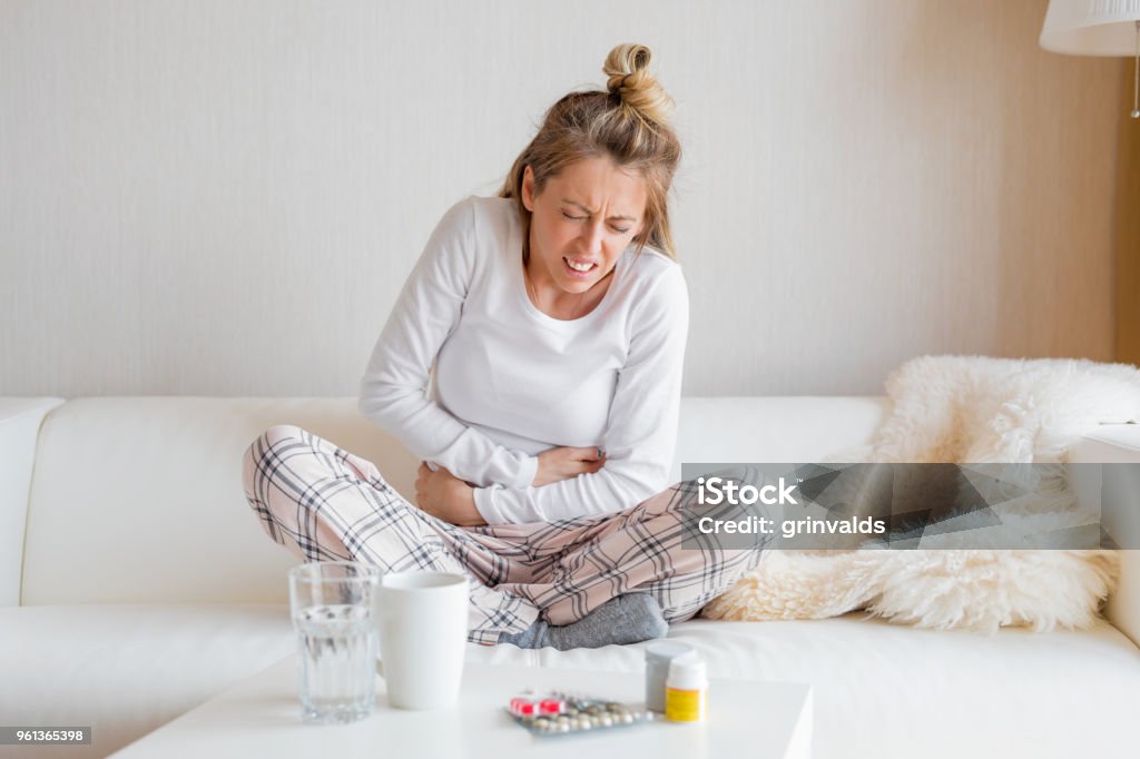 Woman having stomach pain Caucasian ethnicity woman having heavy stomach pain. Abdomen Stock Photo