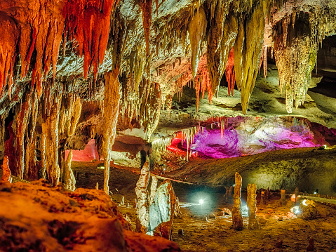Wonderful Prometheus Cave. Stalactites and stalagmites in the illuminated cave.