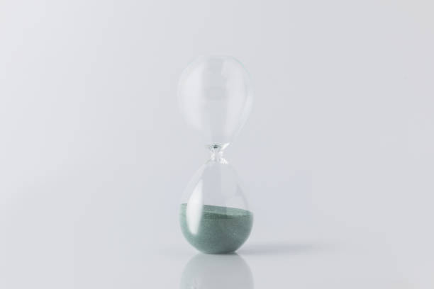 istock close up view of sand clock isolated on white 961376526