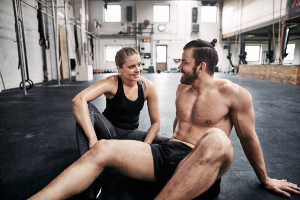istock Two fit people relaxing on a gym floor after exercising 961379892