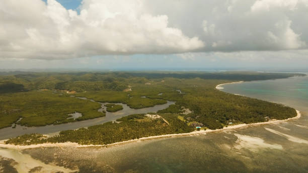 istock Seascape with tropical island, beach, rocks and waves. Siargao, Philippines 961380652
